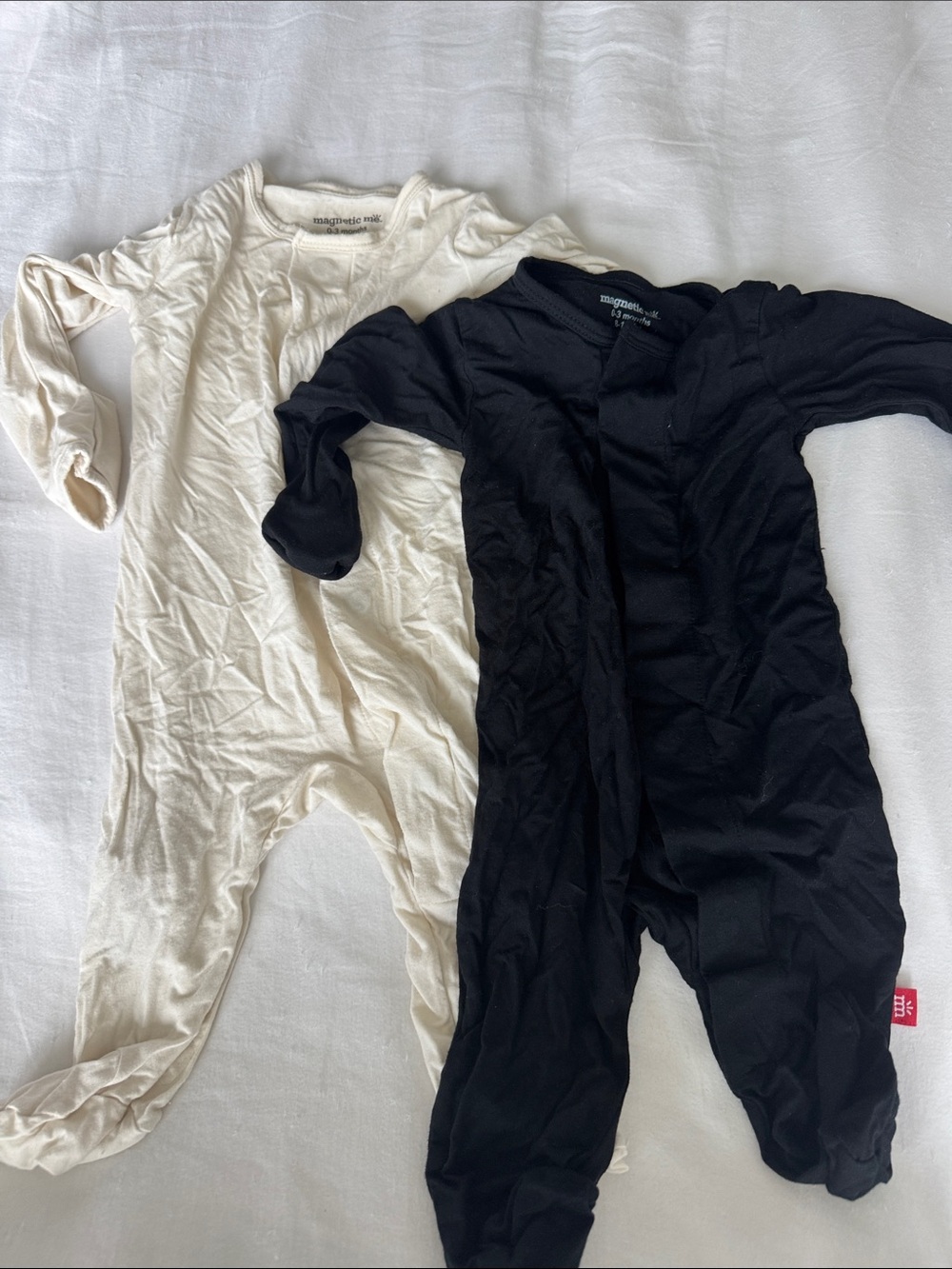 Magnetic Me cream and black long sleeve footed baby onesie sz 0-3 months